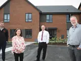Councillor Kelly and others welcome the first resident