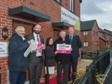 Salford City Mayor Paul Dennett and Derive directors, Councillor John Merry and Councillor Tracy Kelly outside a new home